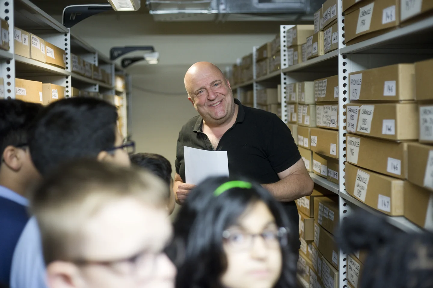 Jon Everall senior conservationist at City Archives takes pupils on a tour of the Strongrooms.
