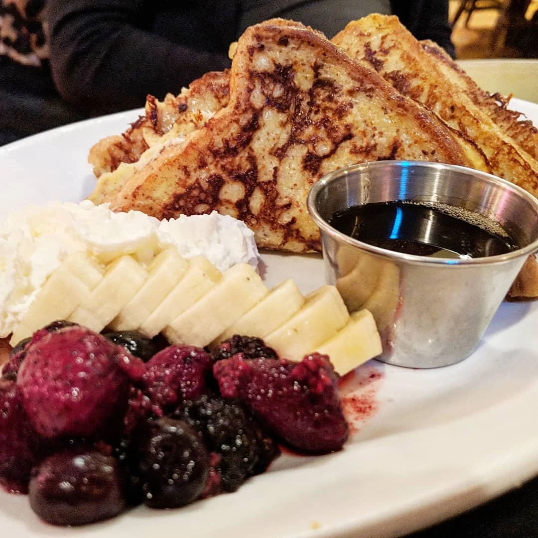 French toast with fresh fruit, whipped cream and syrup