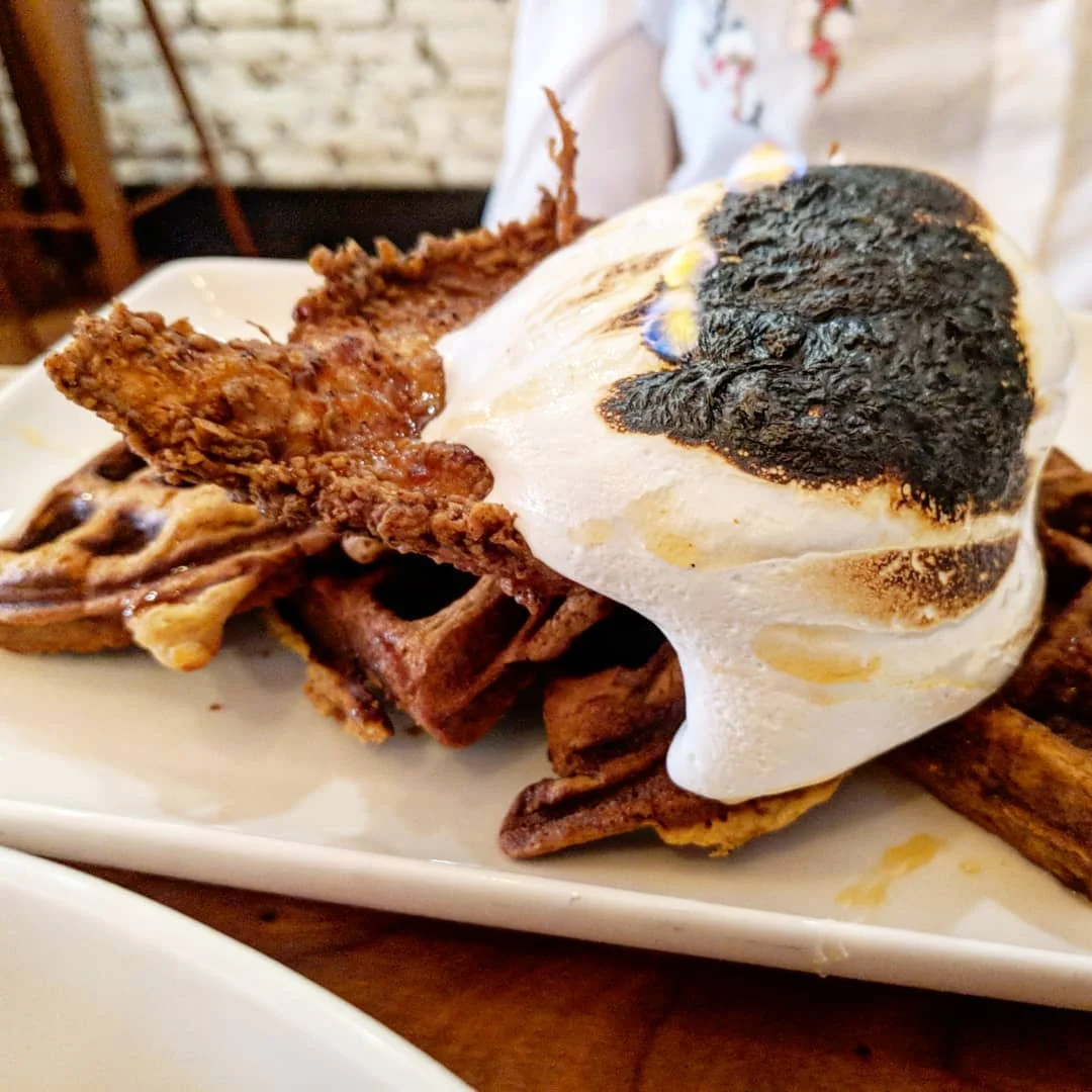 Chicken and Waffles: Buttermilk Tabasco Chicken, Sweet Hash Waffle and Honey Bourbon Marshmallow still on fire when it gets to your table!
