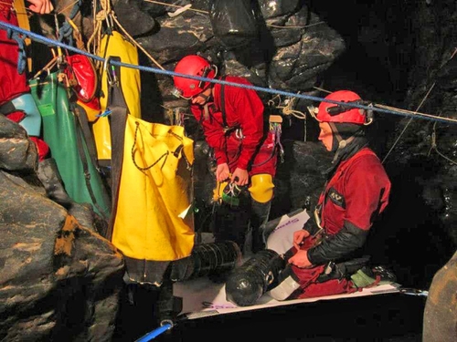 A team of cave diving specialists prepare to explore beyond the 840 Sump- a single dive that stretches over a quarter mile- 2,755 feet beneath the surface of the earth. /photo by Jarvist Moore Frost.