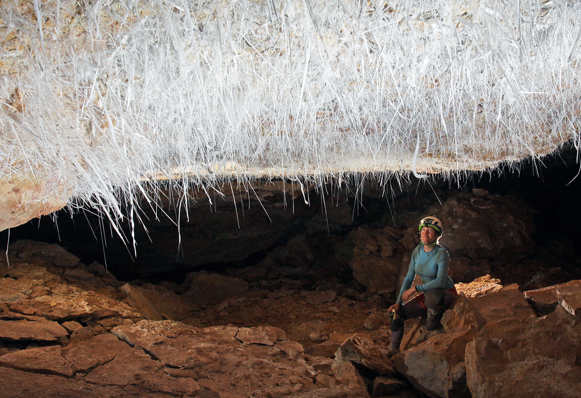 Author, Jean Krejca admires needles of selenite in an Arizona cave. Photo by Steve Eginoire