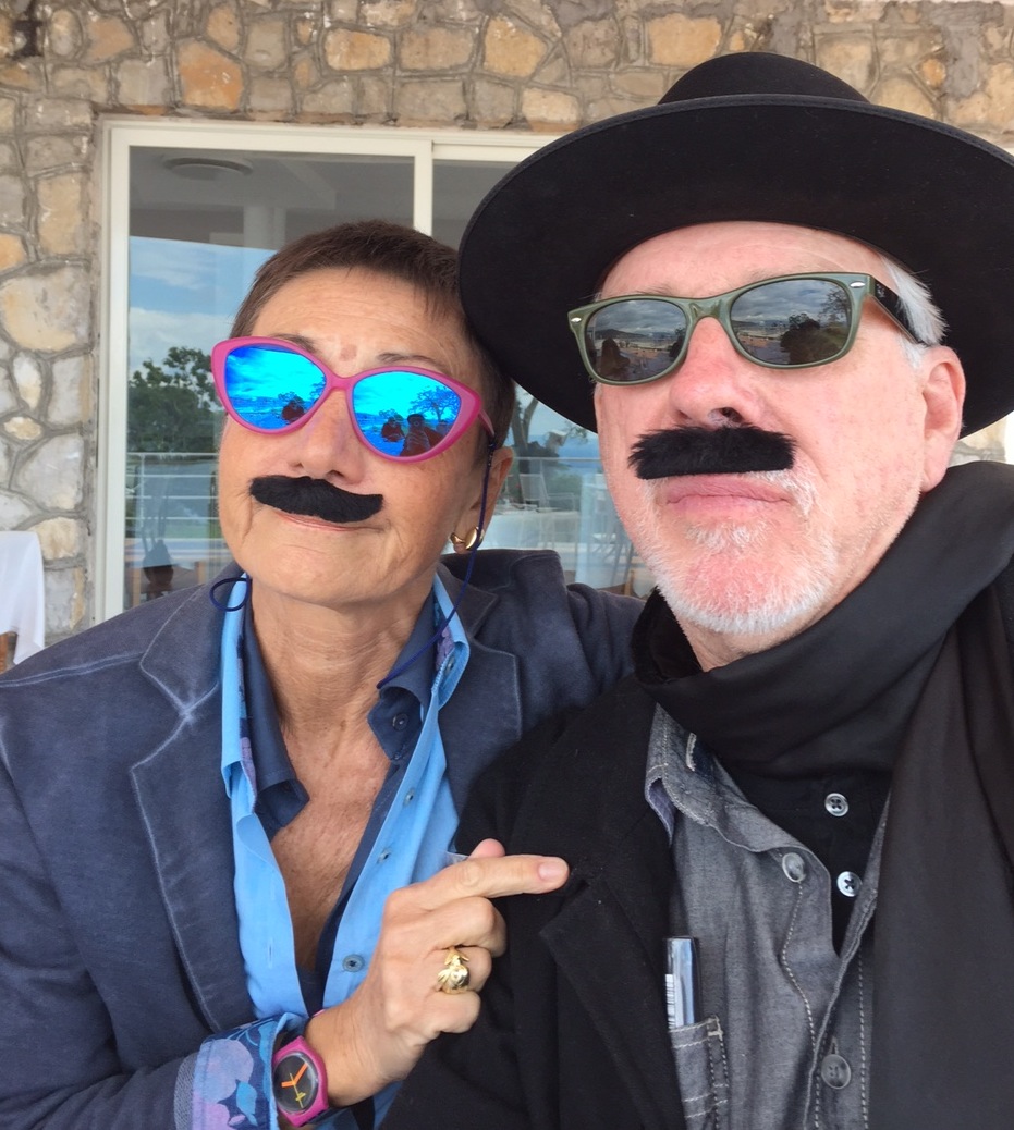 Cynthia Penna + artist Eric Johnson yukking it up, mustachioed.