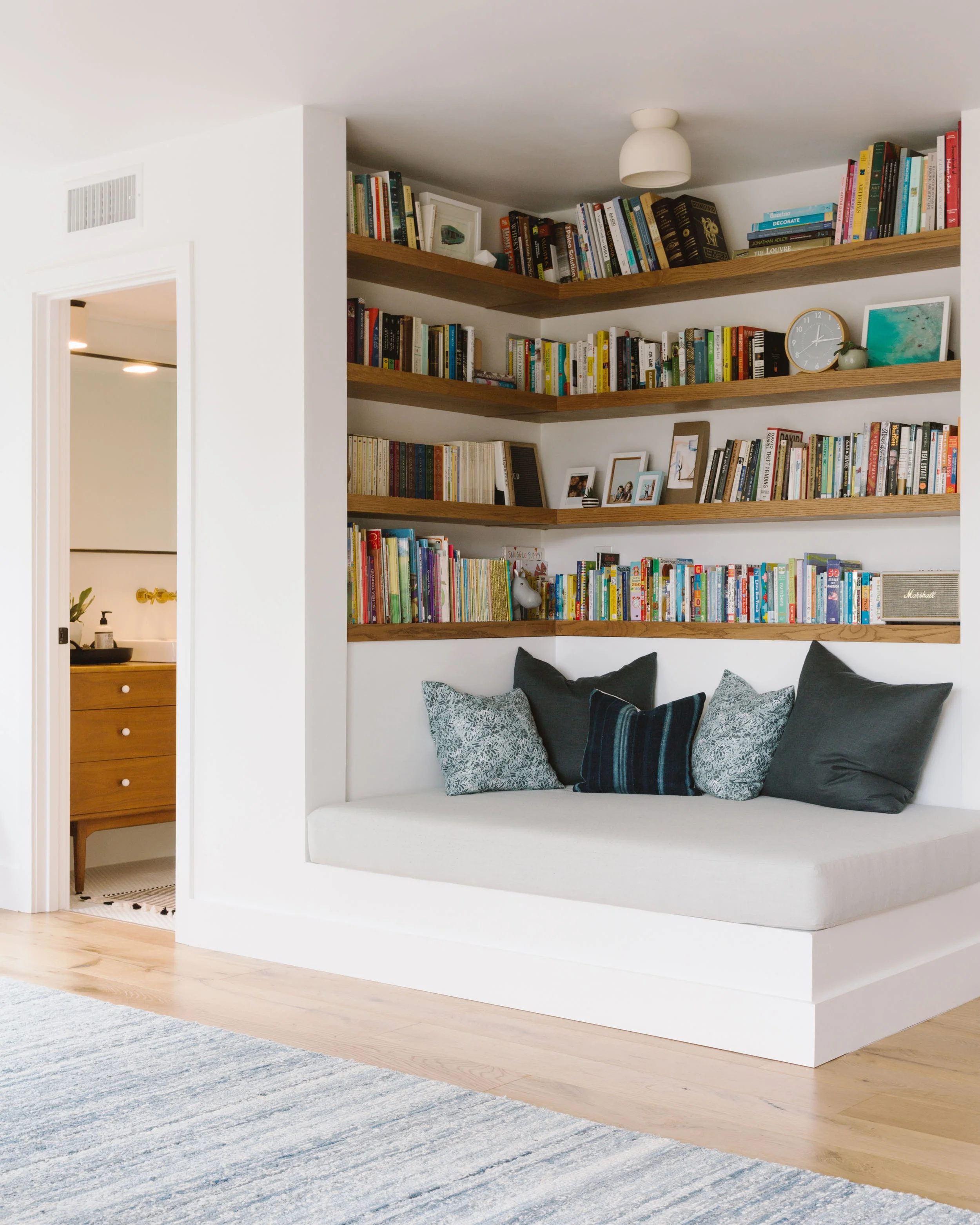 Reading nook utilizing an otherwise blah corner by Samantha Gluck Interiors .