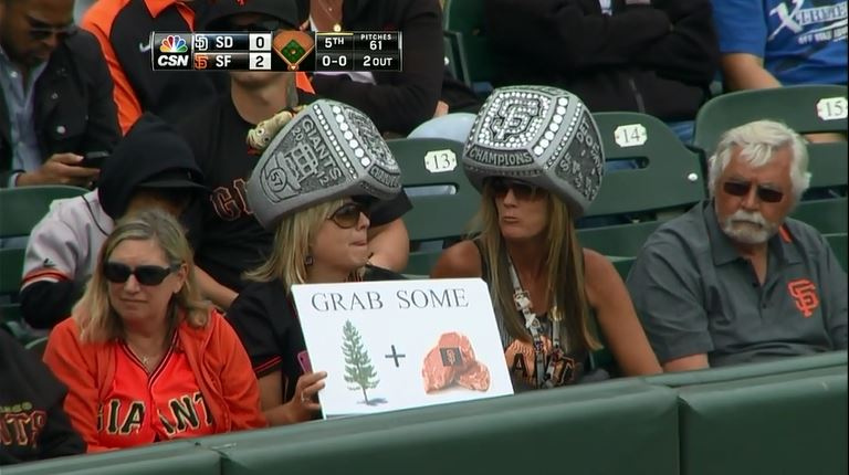 This is real, ok? Not some overly affectatious soccer team or supporters that try to copy Italian ultras. No, this is two women wearing oversized ring hats, with a nonsensical sign, in a mostly filled ball park surrounded by people who want to do the wave, drink beer, and talk about the upcoming NFL season.