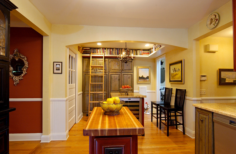 A butcher block countertop island completed the look of this cottage remodel. | Designed and built by Forward Design Build.