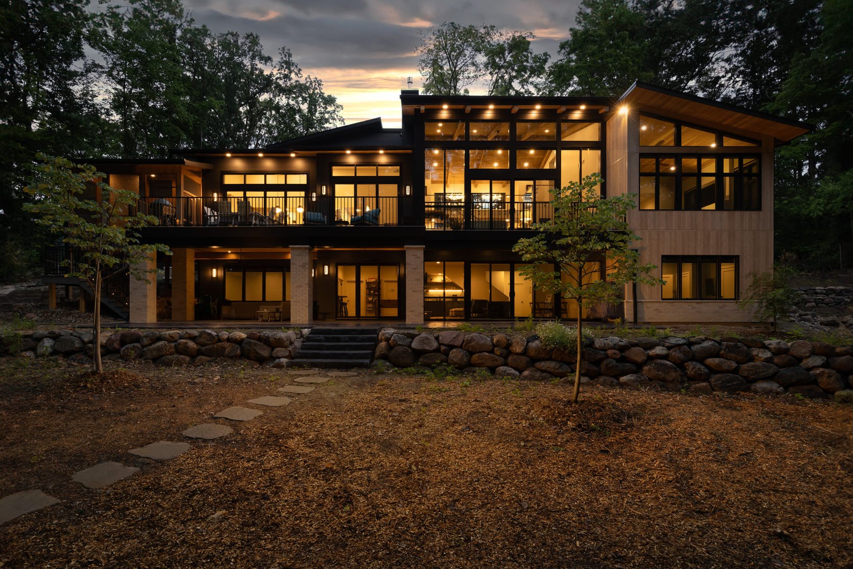 A large house sitting on top of a hill in a custom home in Ann Arbor by Forward Design Build Remodel.
