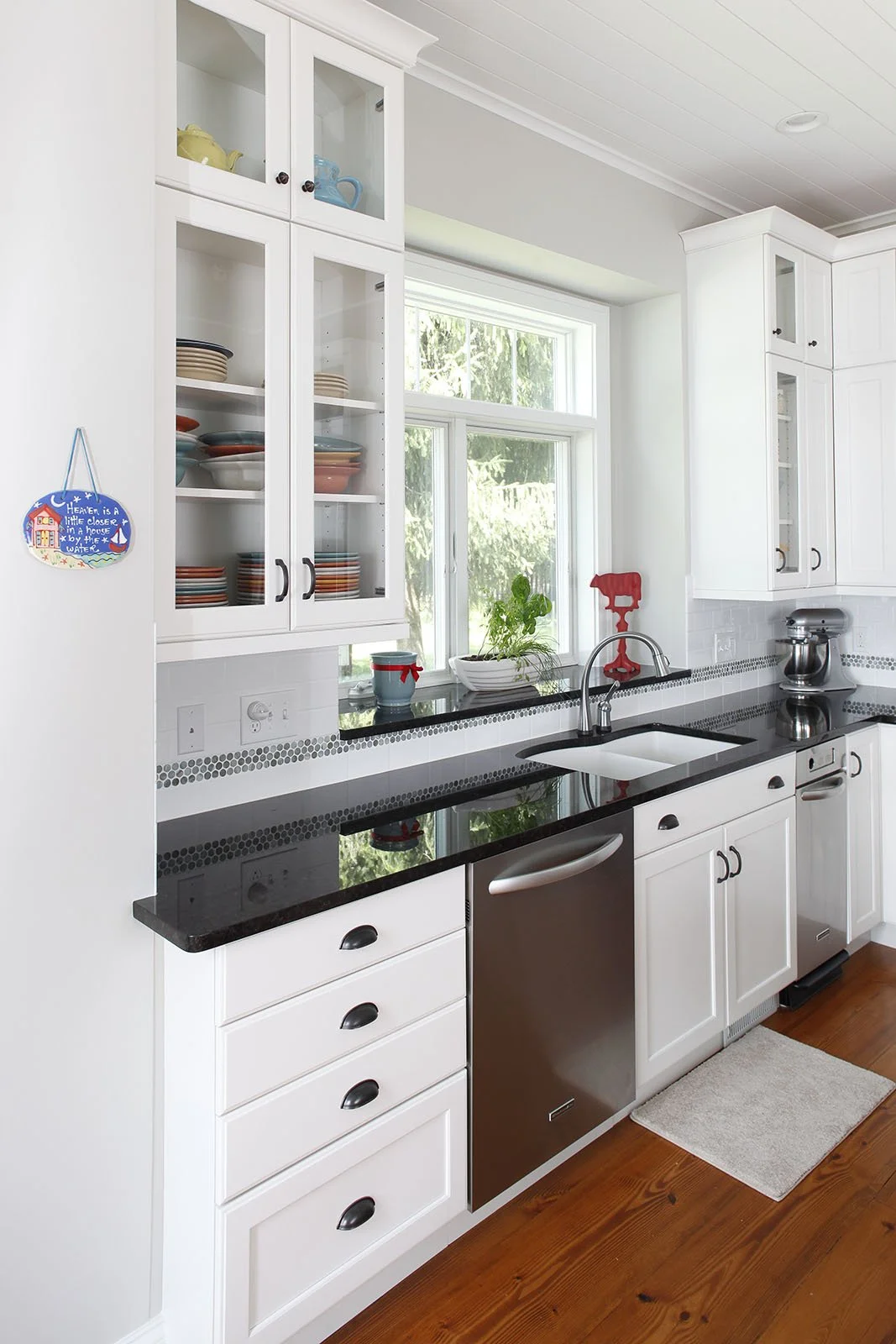 Bright White Glass Front Cabinets In Kitchen In Lakehouse Transformation In Custom Home by Forward Design Build.jpg