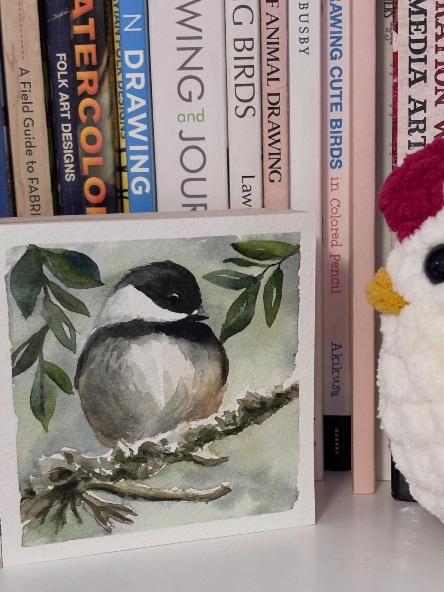 A little vignette of a chickadee and a chicken. Watercolour on wood panel and the chicken by @thenewmercantile. It&rsquo;s been ages since I&rsquo;ve posted.  I guess I just lost my social media mojo.
#watercolorpainting #birdart #chickadee