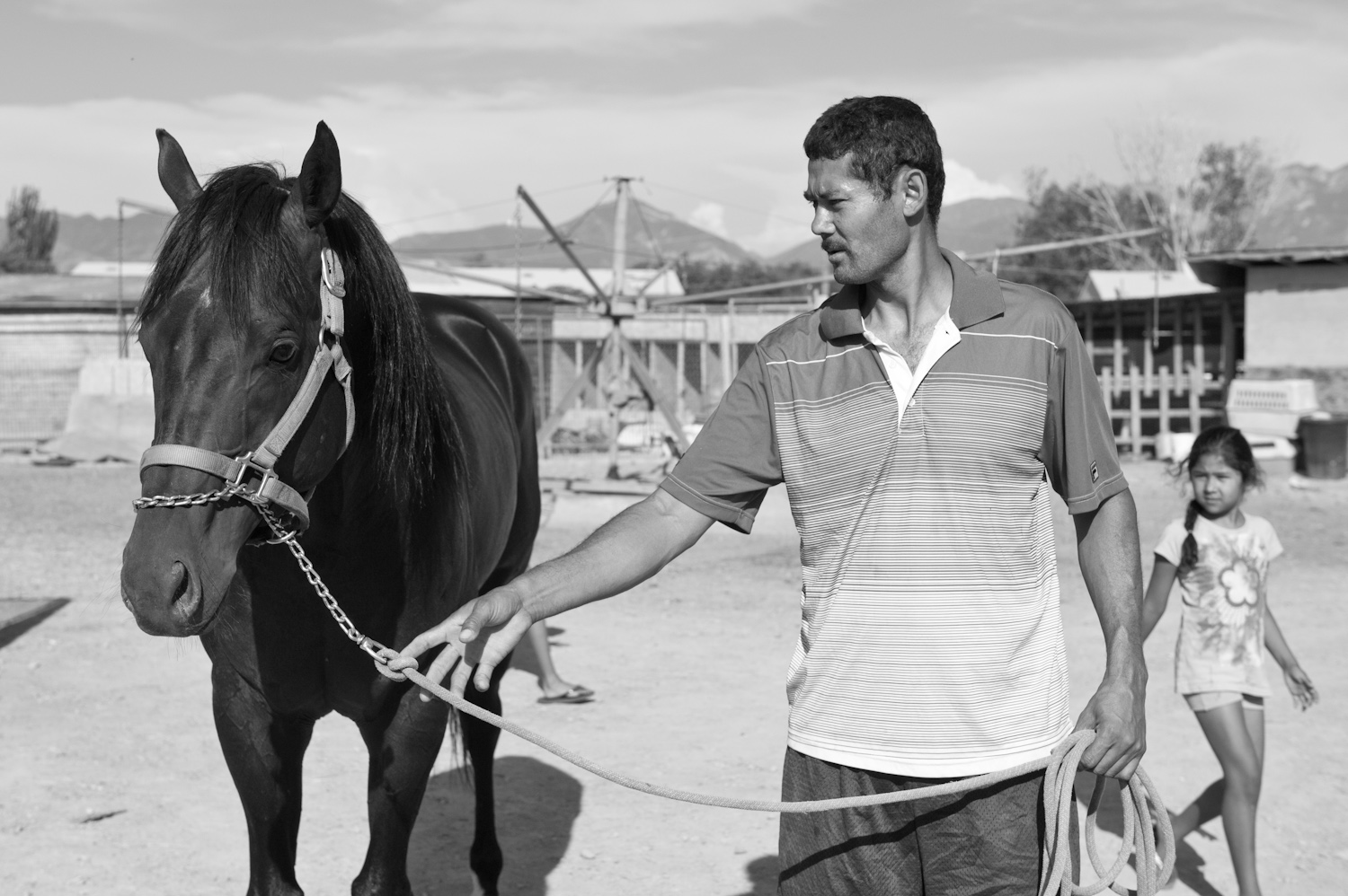 Jose Luis Pimentel leads his horse across his farmyard.