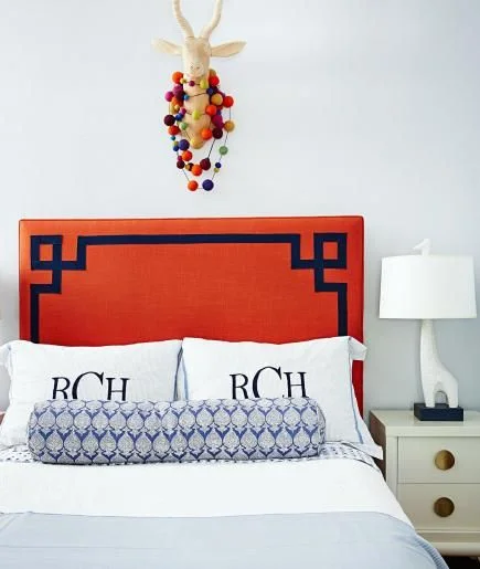 I'm loving the accent trim on the headboard with the jonathan adler giraffe lamp.  via midwest living