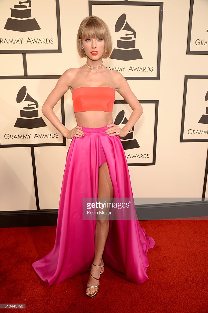 Taylor Swift in a bandeau top and full hot pick skirt. She's also looking a bit like anna Wintour with her shorter bob