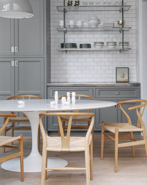 i clearly love this kitchen a lot because i recently featured it for the metal shelves . but also take note of the wishbone chairs , they are becoming quite popular