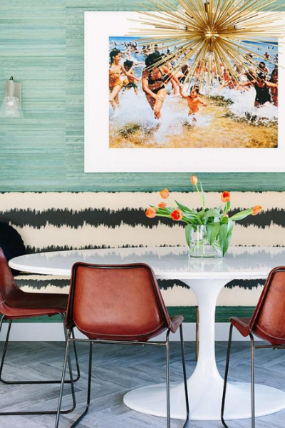 the green grasscloth accentuates the black and white pattern on the banquette
