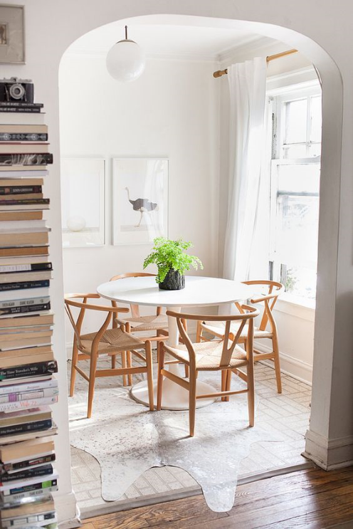 between the archway, the books, the table and chairs, chandelier, and rug, you would never notice the ugly linoleum. designed to perfection! via p op sugar