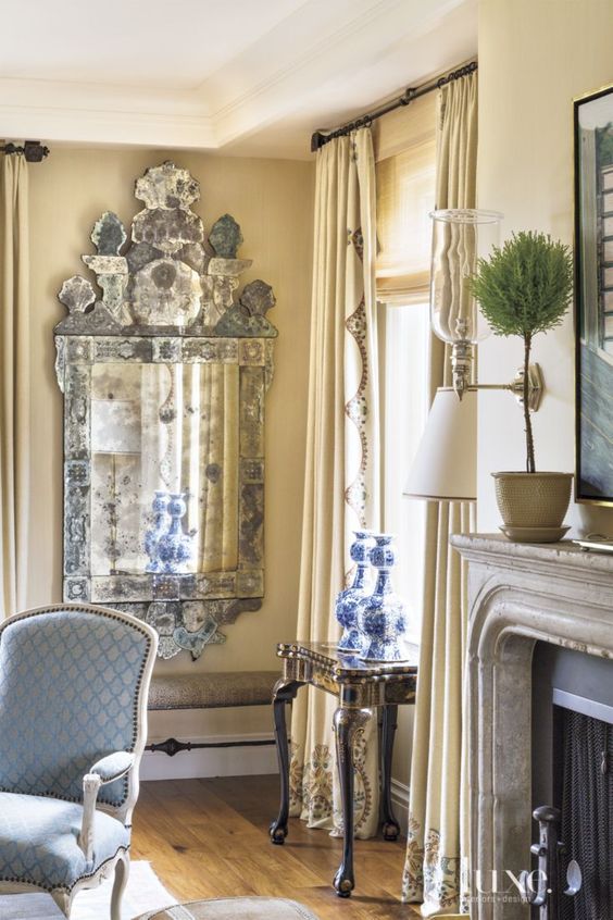 Let's also take note of the detail work on the drapes, the end caps on the drapes, and the iron stretcher on that bench! via luxe 