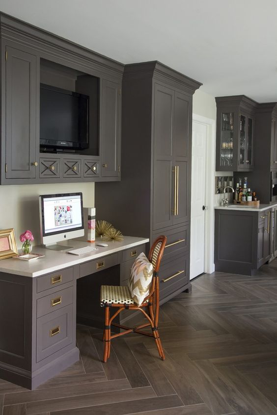 i love everything about this kitchen space. the cabinet color with the brass hardware, the small drawers with an architectural feature, and the tv! And if the witching hour gets to be too much you're just a few steps away from the bar