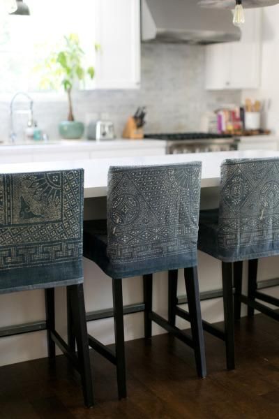 I'm kinda dying over these denim slipcovered barstools with a stencil pattern over them. So unique and one of a kind