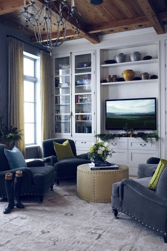 the cremone bolt is highlighted as an architectural feature to this space. I also really love the blue velvet chairs with the chartreuse pillows