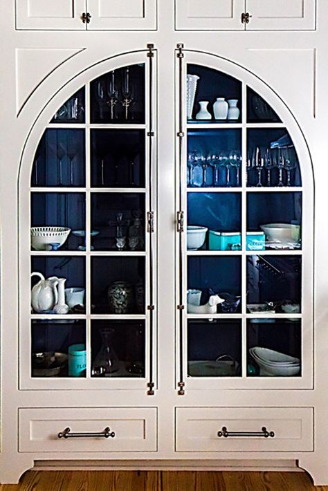 Who doesn't love an arched door cabinet with a painted interior?