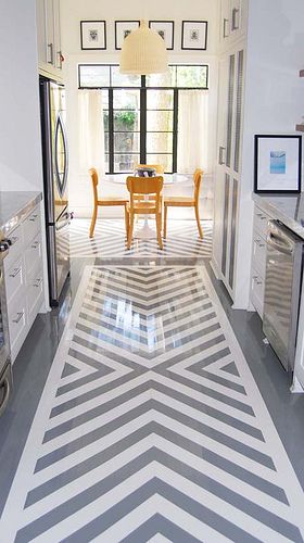 I don't know if this is epoxy or what, but sign me up for high gloss floors! And note how the pattern is also brought into the eat in kitchen under the table. 