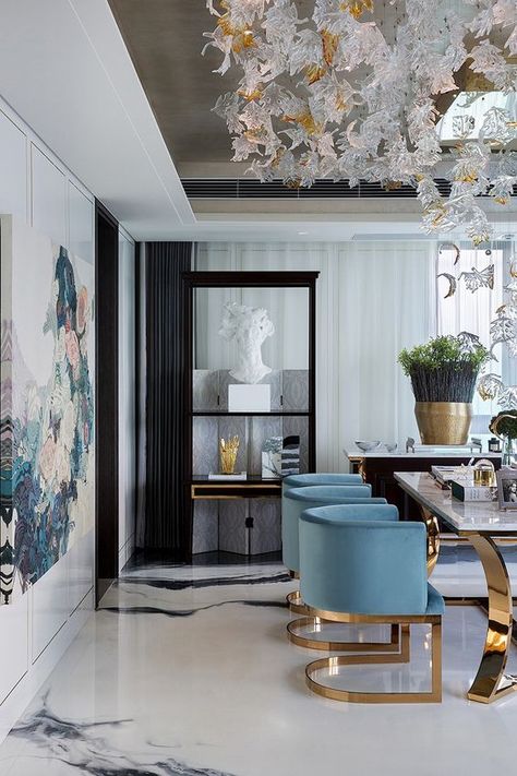 A modern dining room doesn't have to feel cold. bring in some velvets, a bit of color and some brass and you've warmed your space right up