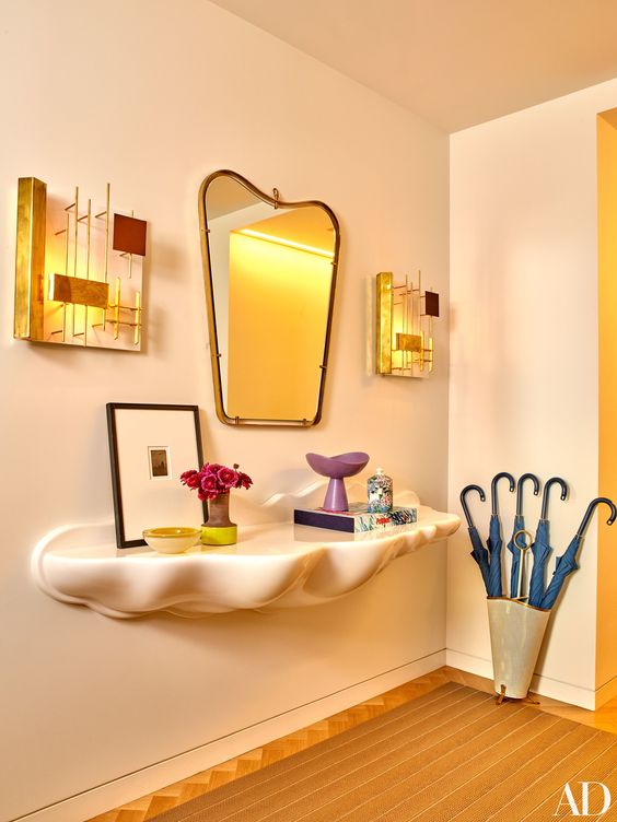 I can't stop looking at the border pattern in the foyer and those vintage Gio Ponti sconces.