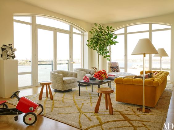 The other side of the Living room with a separate seating area featuring the mustard sofa. Again with those windows!! 