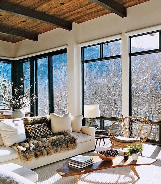 Although this room is mostly windows, and the walls and sofa are white, this room has such a warm feeling. White doesn't have to be stark and cold.