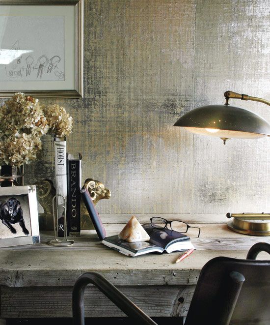 I like this high contrast between the metallic wallpaper and rustic desk. And can we just take a moment to look at his framed artwork?! 