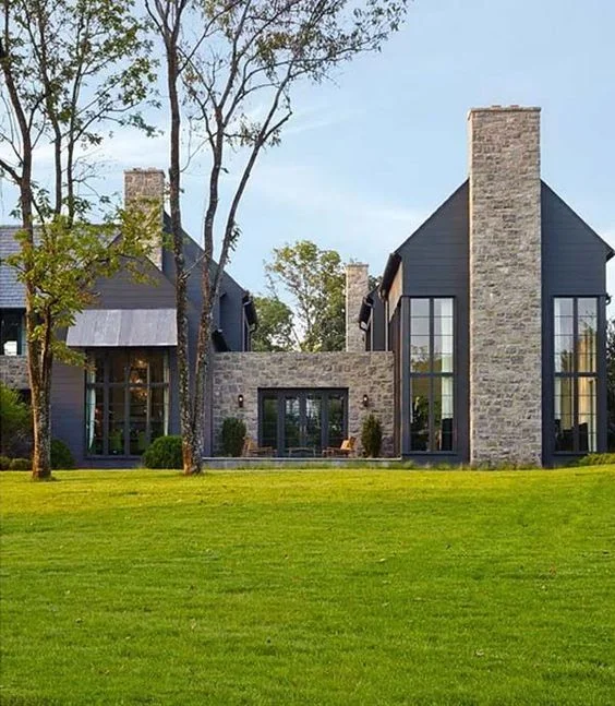 A modern take on a traditional farm house situated on an old civil war site in nashville, tennessee. I PARTICULARLY like the mix of the metal awning with the stone and black. 