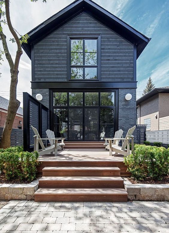 the large wall of windows help break up the darkness of the black. 