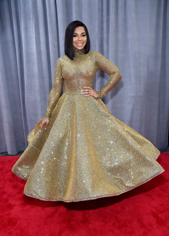 Ashanti arrived in a Yas Couture by elie madi gold, wavy, full gown. It didn't hold up to the camera's flash so well but it's still a special look. 