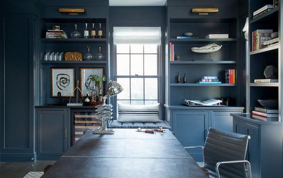 The brass picture lights really pop off the blue built-ins and room. 