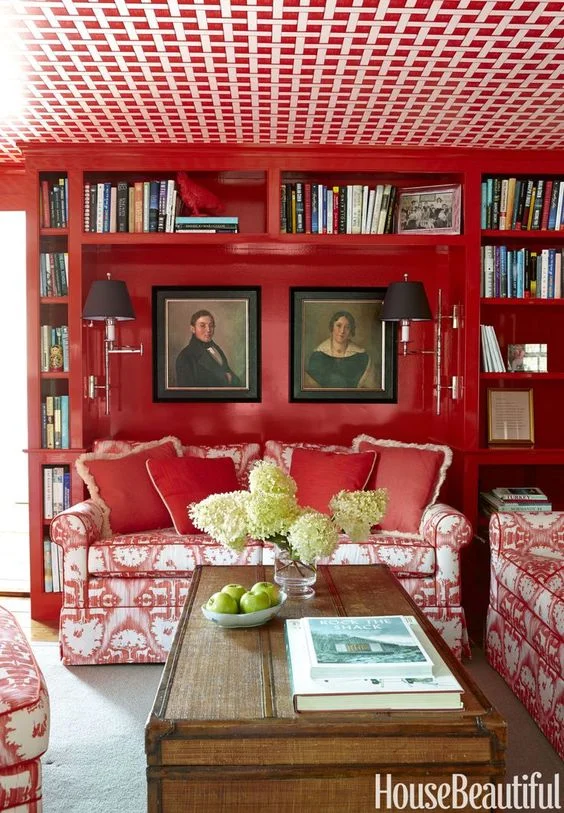 a prime example of how you don't have to paint your entire room from floor to ceiling red, but by breaking up the red with white for the ceiling, still lends itself to a bright room . 