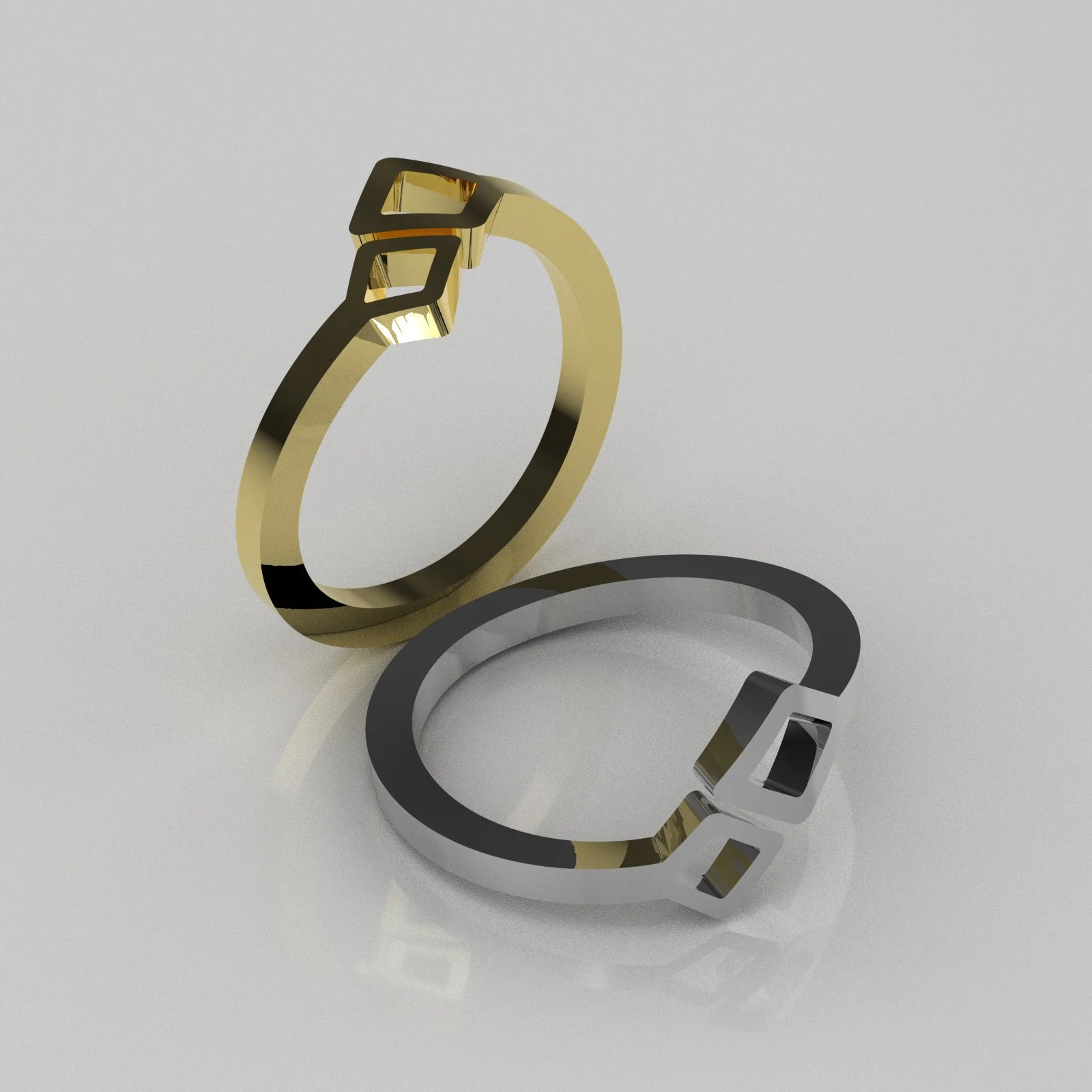 Two metallic rings, one gold and one silver, with cut-out logo design, placed on a reflective surface.