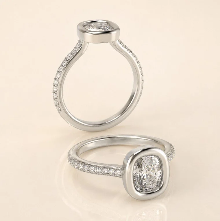 Two platinum engagement rings with large central diamonds, surrounded by smaller diamonds, set against a cream background.