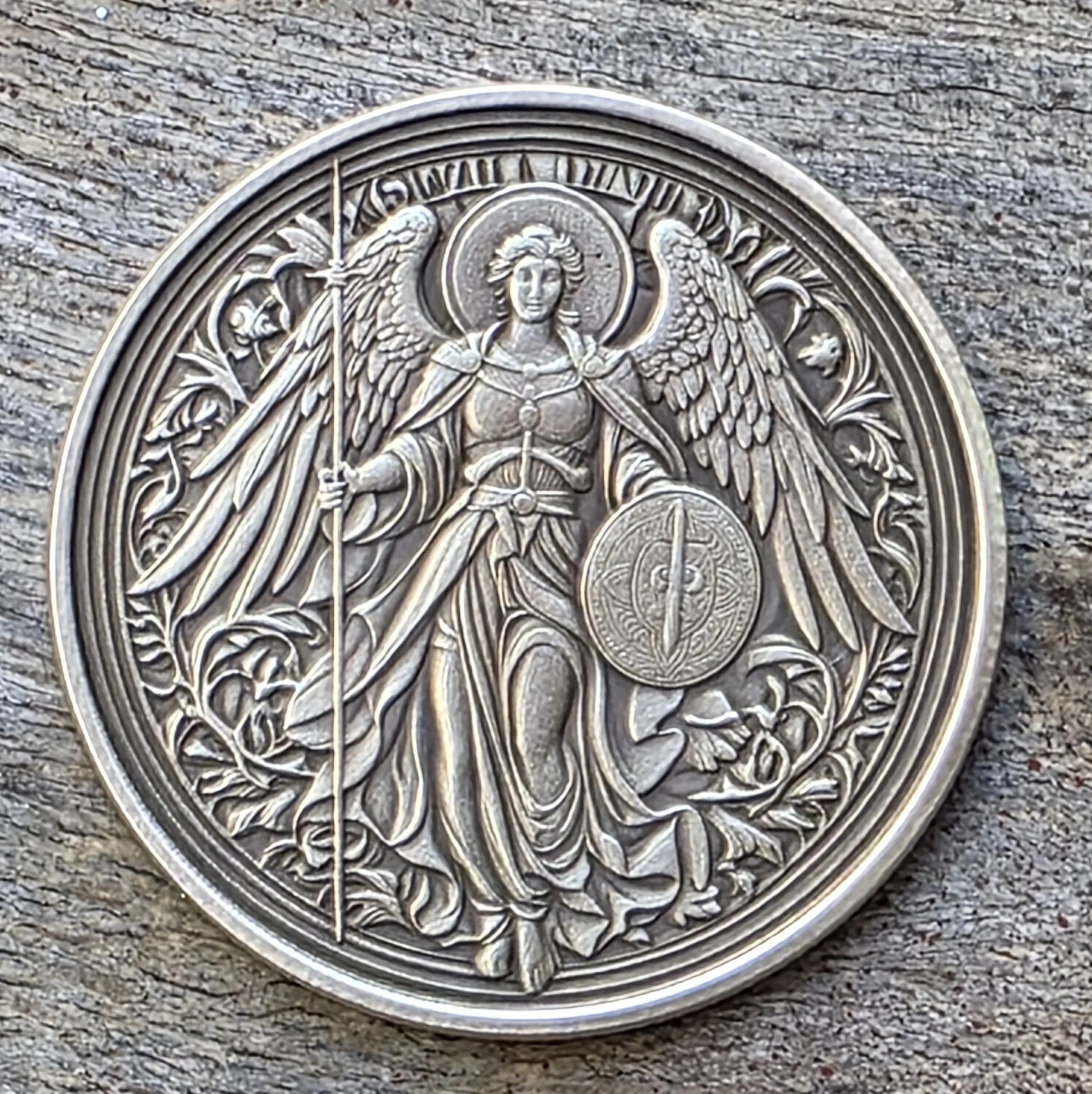 A detailed, custom-made circular pendant, coin with Saint Michael.