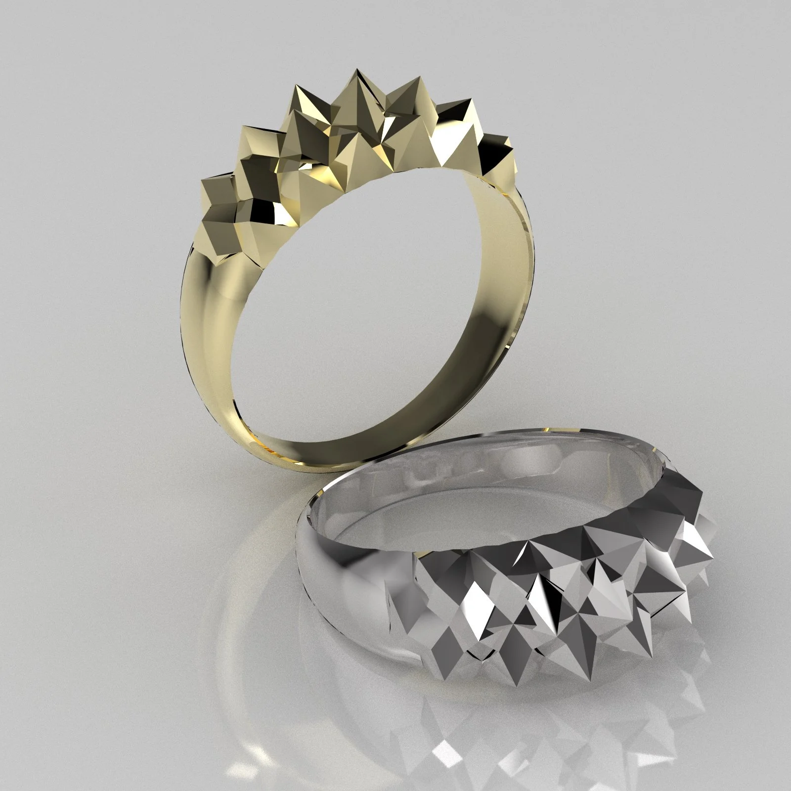 A gold ring with geometric, faceted design on a reflective surface, contrasting with a metallic, angular object underneath.