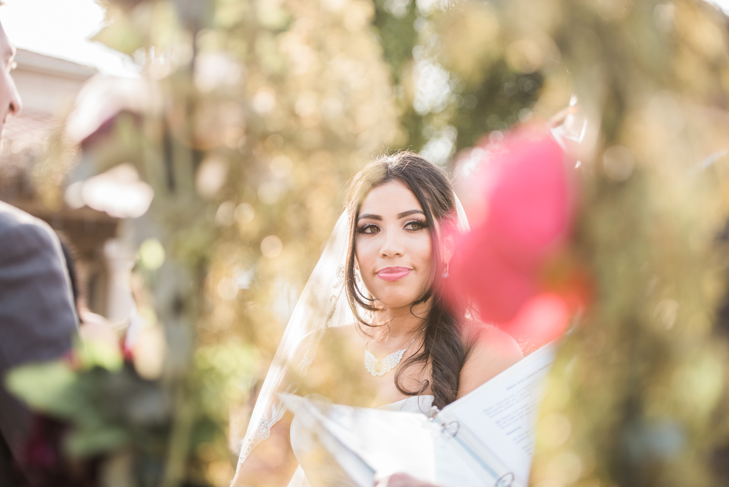 Bride at the alter | Picture shot through the flowers