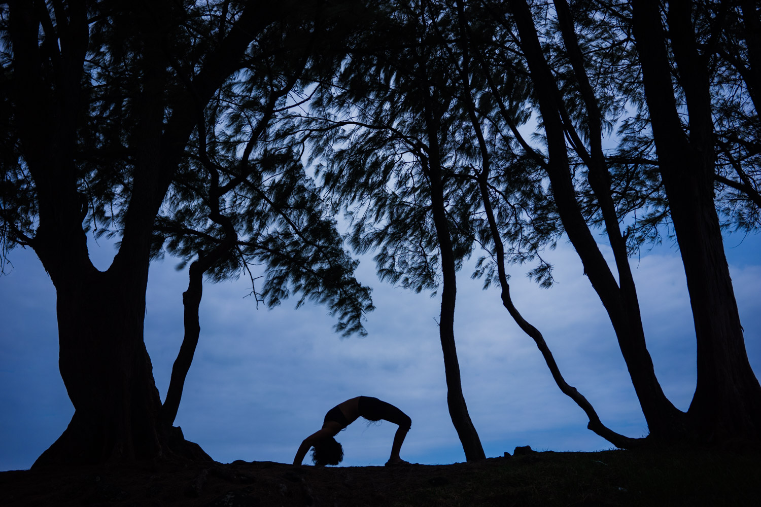 Yoga Wheel pose at laupahoehoe beach point in hawaii.