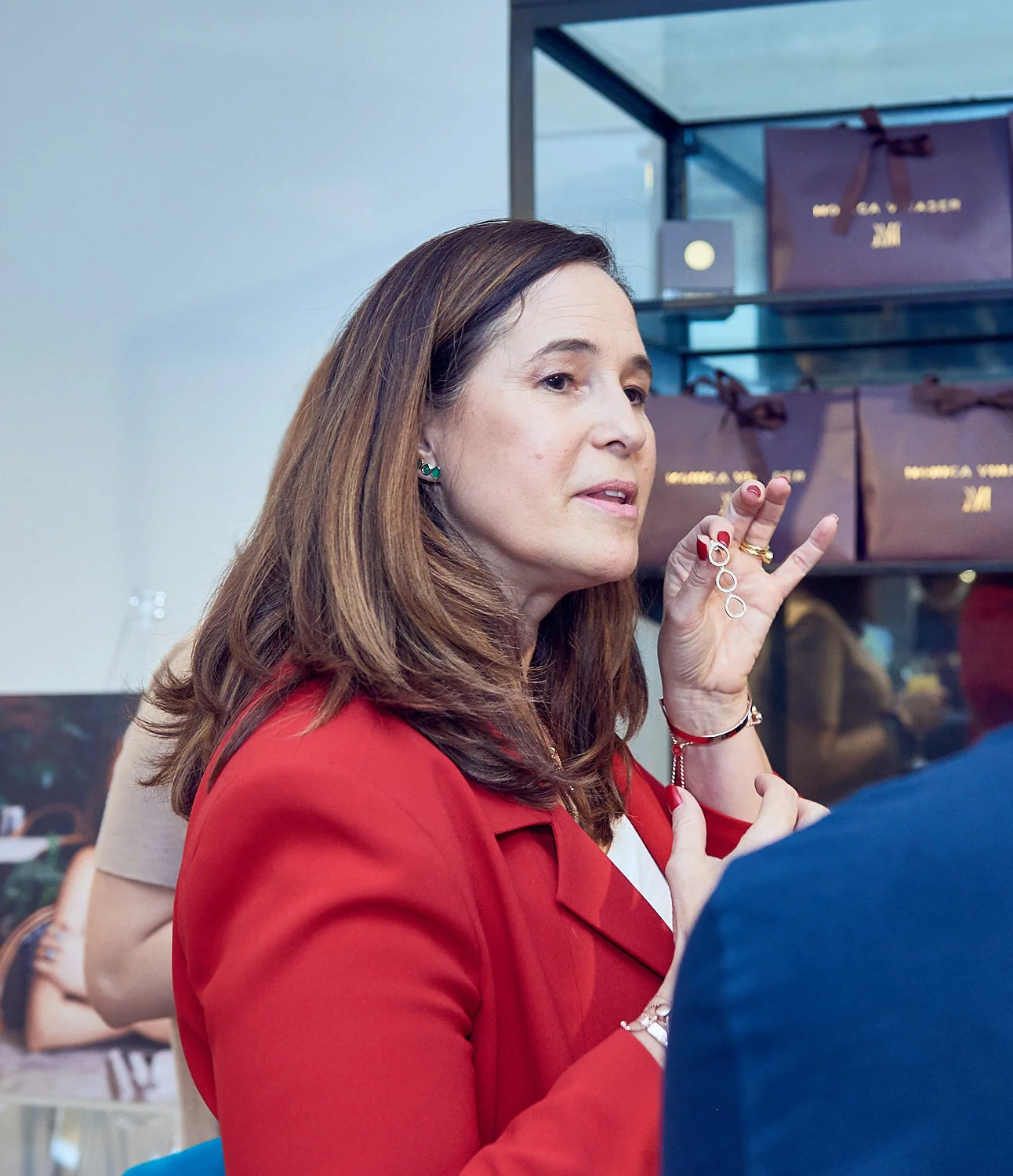Monica helping guest in picking the designer earrings.