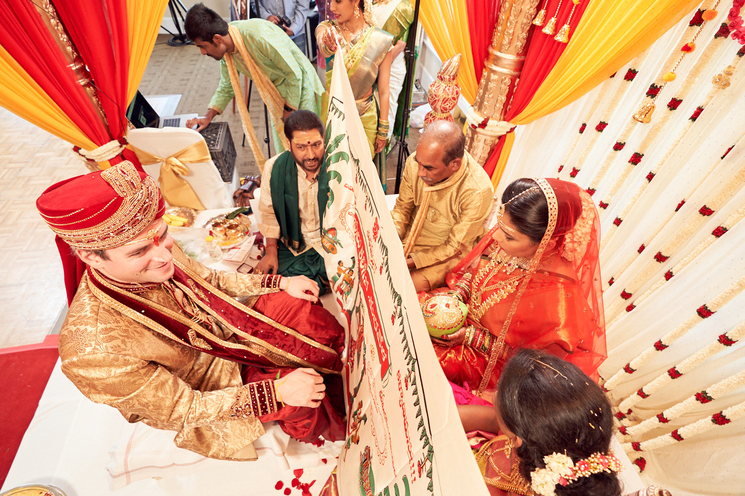 Groom eager to see his bride on the other side of the holy curtain during telugu wedding ceremony.