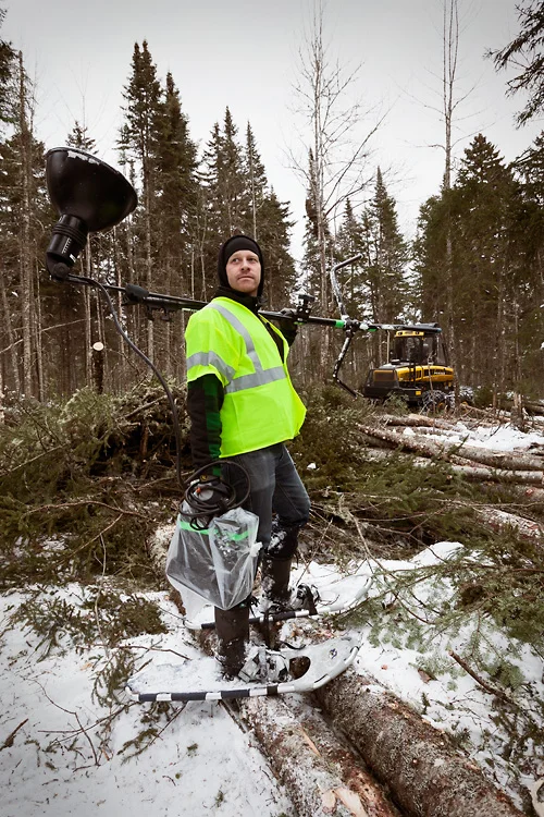 Aaron Hoskins sporting snowshoes while traipsing through the forest with our battery lighting kit.