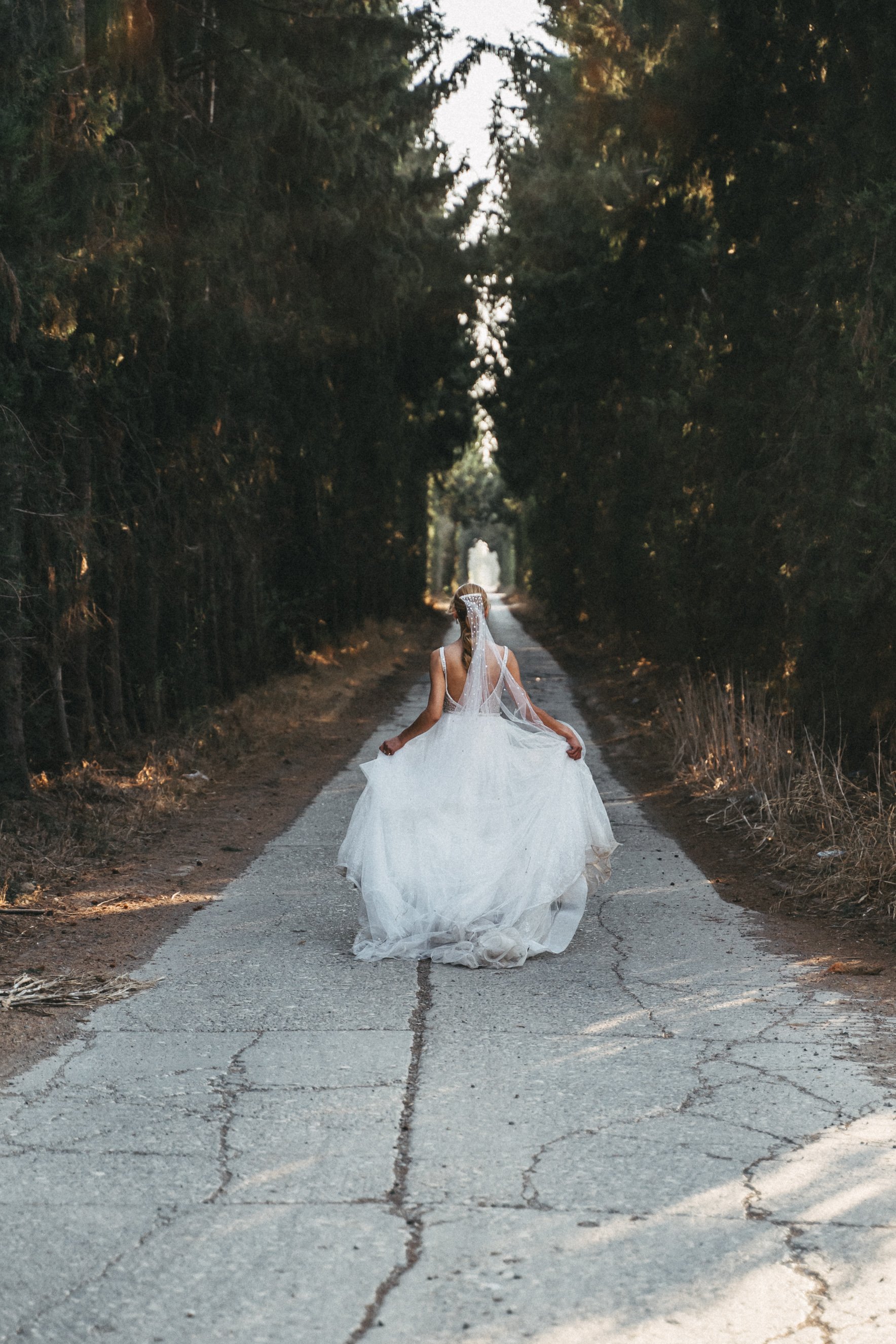 Ethereal fine art photograph captured by a Cyprus wedding photographer of a bride and groom in a forest of autumn leaves on the island