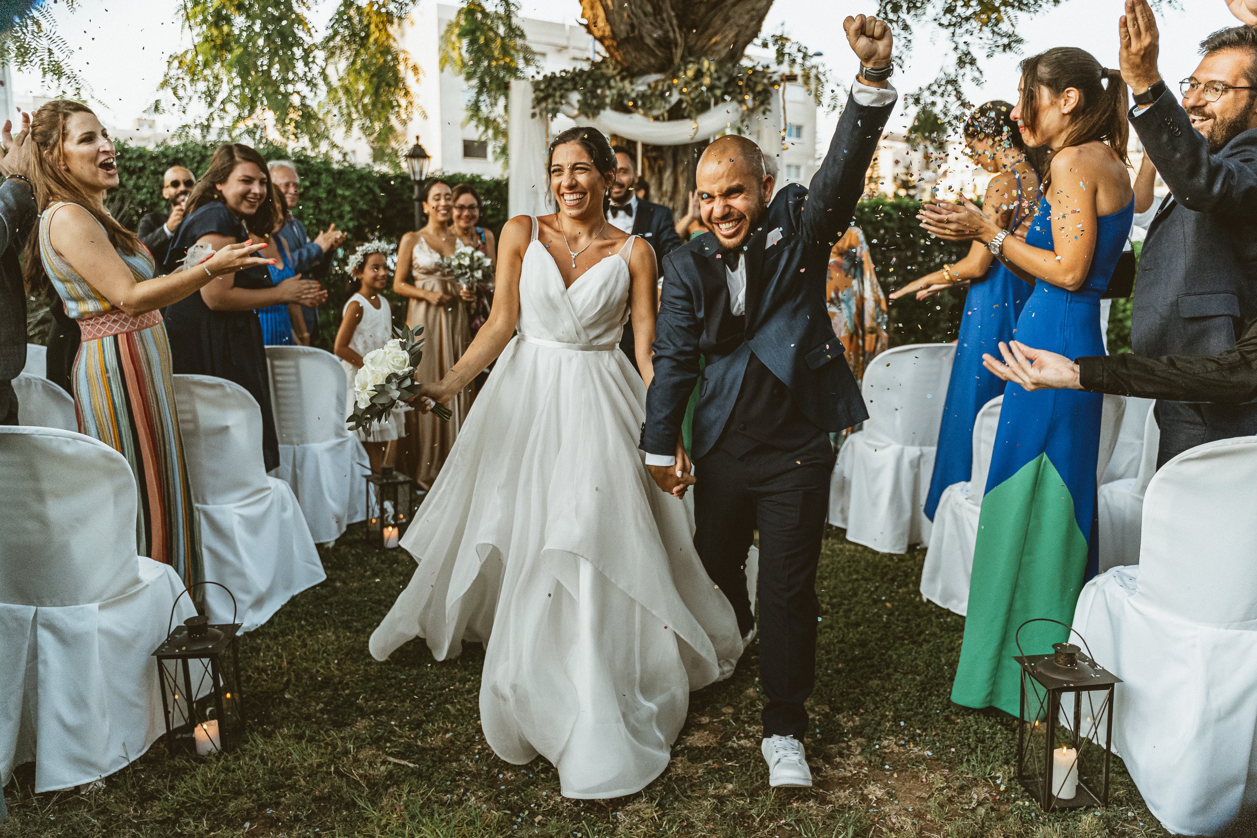 Whimsical fine art photograph of the bride and groom in a flower-filled garden, captured by a Cyprus wedding photographer