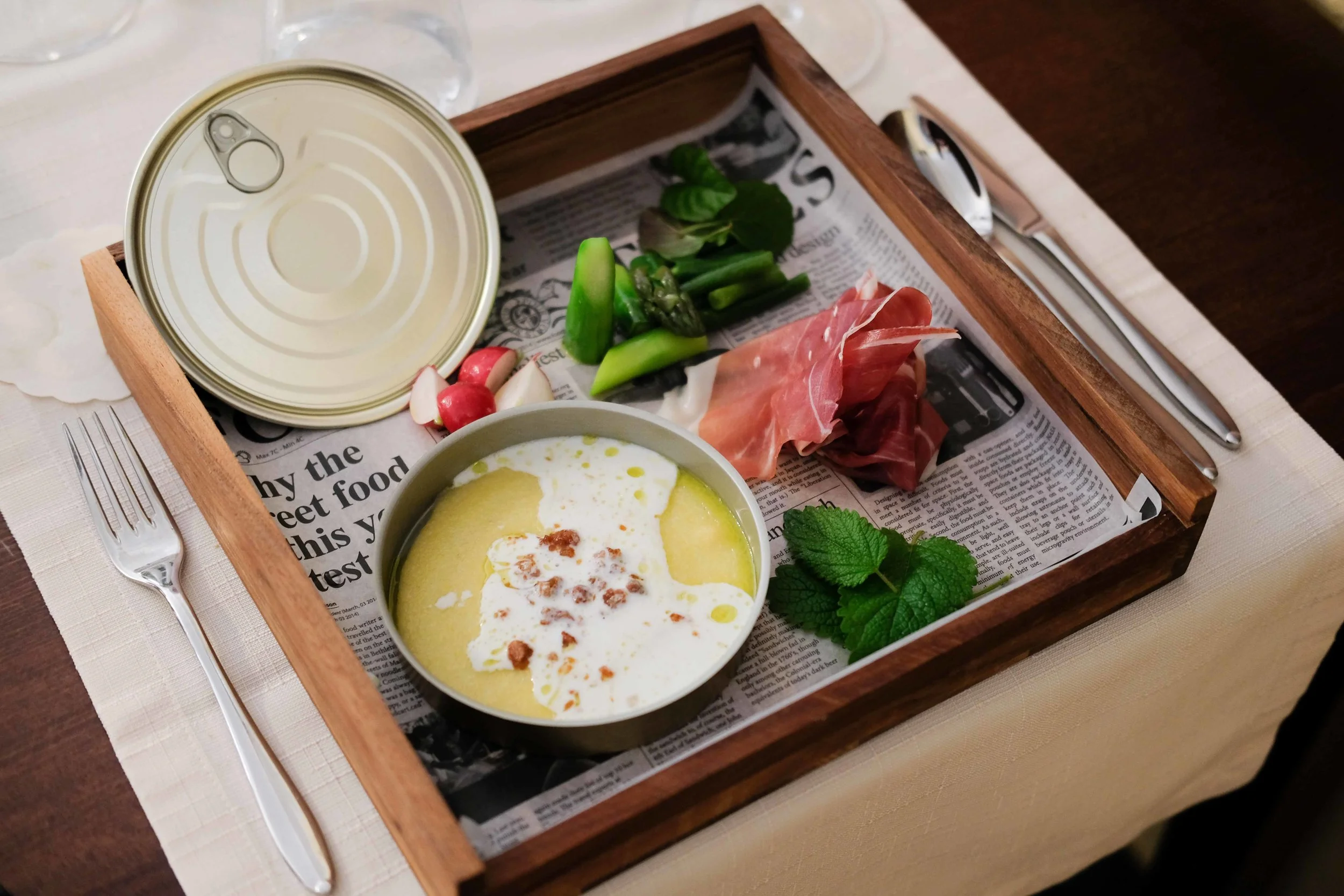 Appetizer: polenta with cream and pancetta, prosciutto, asparagus and mint. The sour cream with olive oil were poured from a long thin vial onto the polenta. After the lid had been removed from the container!