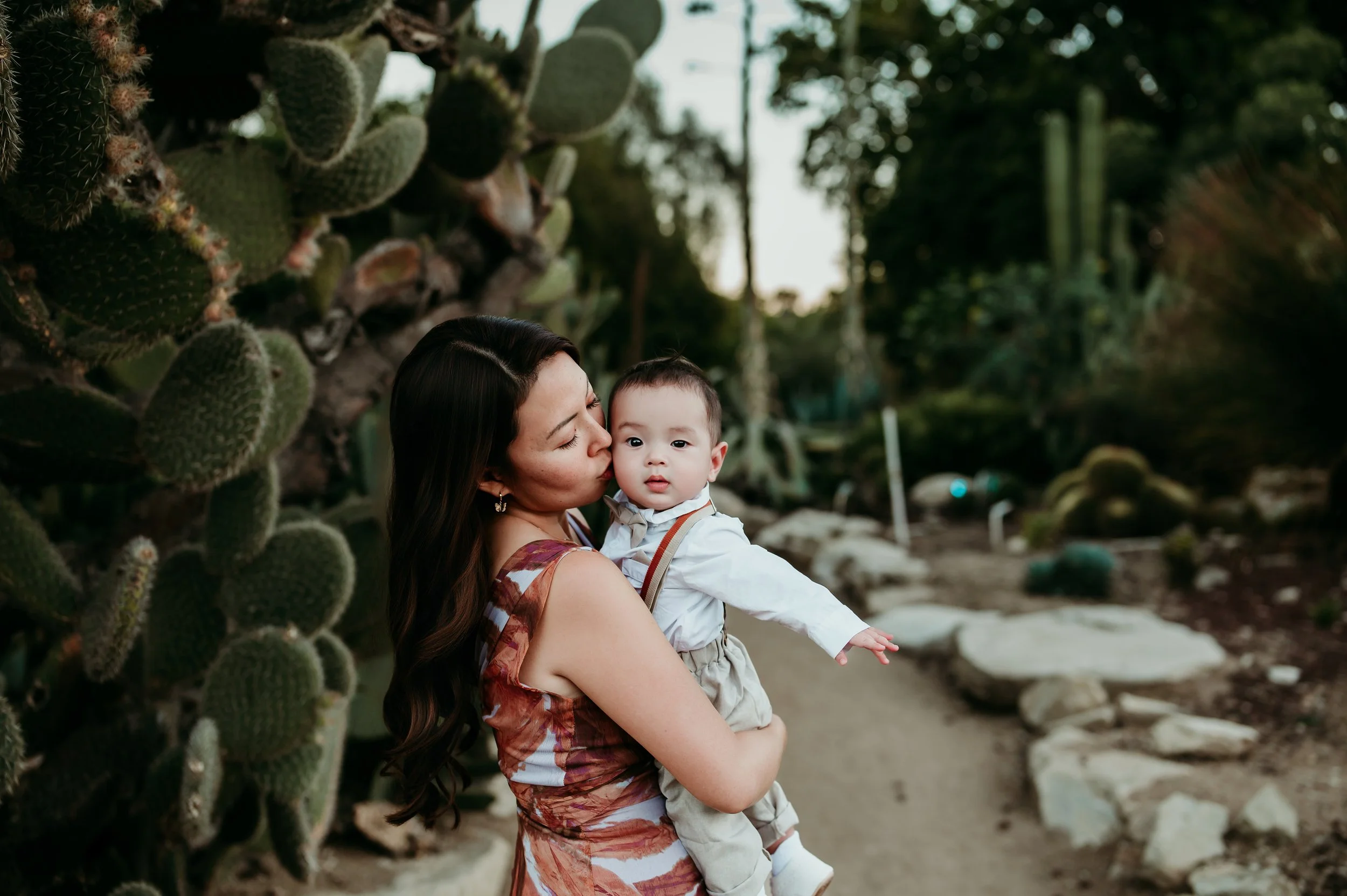 Mother holding child during family photos at South Coast Botanic Garden