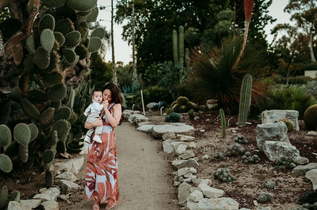 Mom holding her baby in cactus garden in palos verdes south coast botanic gardens