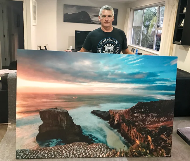 Don't let Simon Gilbert's frown put you off- go big for home, this is Muriwai Ganets at 2000mm wide... and Piha Storm in the background