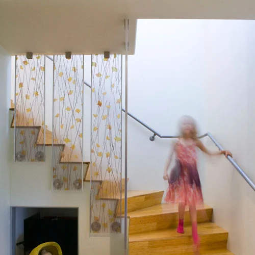 This moderately sized family home mixes traditional Spanish and contemporary design. Contemporary elements such as a rain screen wall system, a canted wall, and a cantilevered bed alcove are used in conjunction with elements of an existing 1935 Spanish style home. The major remodel and addition to a small Santa Monica house has received a Platinum LEED for home rating. The elements that provided character to this small flat roofed Spanish style house have been retained and new more modern elements have been added. The, typical for a traditional Spanish home, bullnose detailing has been recreated with a subtly modern twist at the window sills. The flush wall base, which existed pre-remodel has been updated with a simple reveal. The hard trowel exterior plaster has been reapplied with improved waterproofing and the color of new rain screen wall mirrors the clay roof tiles. The home has been given a new life and, rather than forgetting history, the new and the old elements create a layered whole.